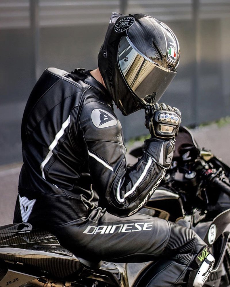 Sportsbike rider in full leathers and carbon helmet